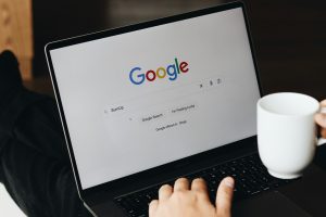 A person sitting in front of a laptop computer